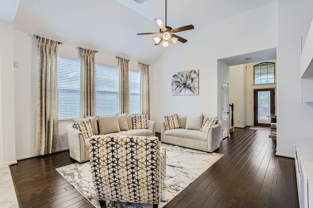 living room with high vaulted ceiling, plenty of natural light, and dark hardwood / wood-style floors