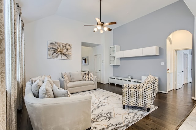 living room featuring dark hardwood / wood-style flooring, ceiling fan, and vaulted ceiling