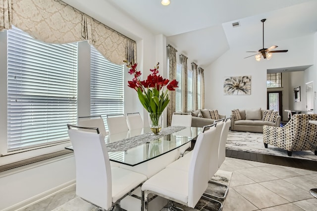 dining room with ceiling fan and vaulted ceiling