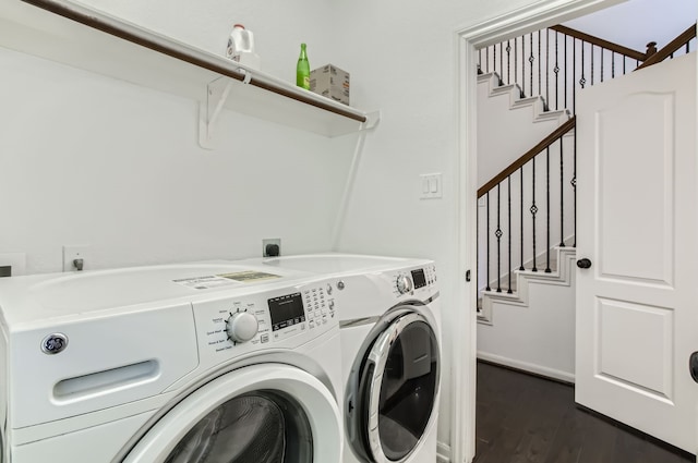 clothes washing area with dark hardwood / wood-style floors and washing machine and clothes dryer