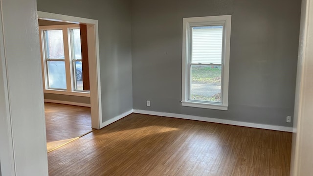 spare room with hardwood / wood-style floors