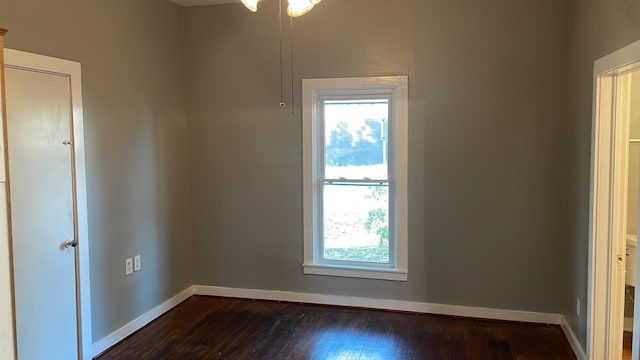 spare room with dark hardwood / wood-style flooring