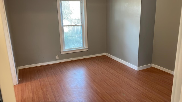 unfurnished room with hardwood / wood-style floors