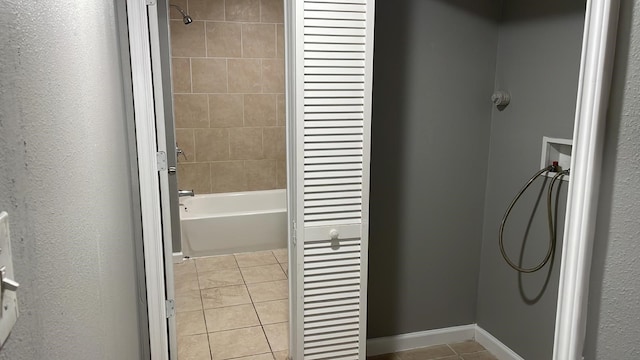 bathroom with tile patterned floors and tiled shower / bath