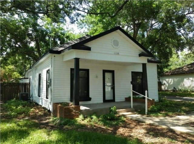 bungalow-style house featuring central air condition unit and a porch