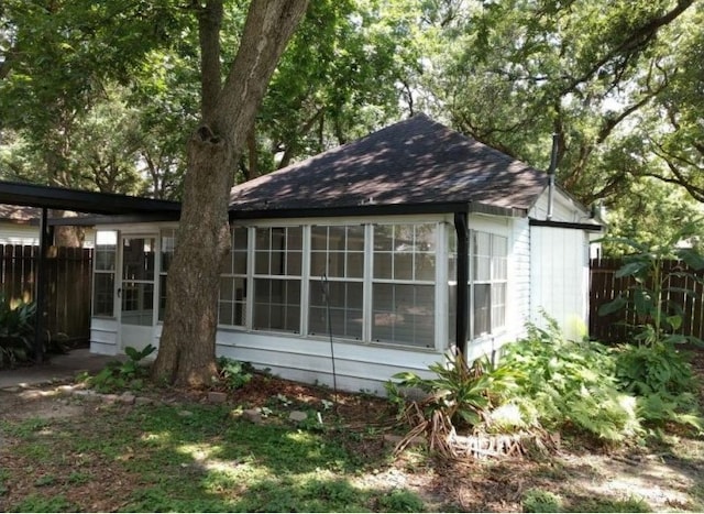 view of side of property with a sunroom