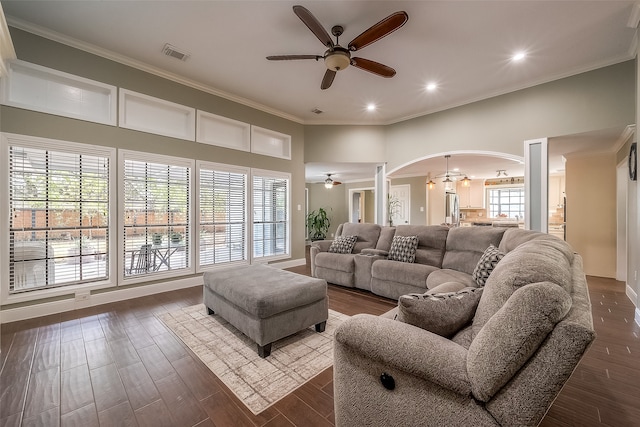 living room with ornamental molding, dark wood-type flooring, and plenty of natural light