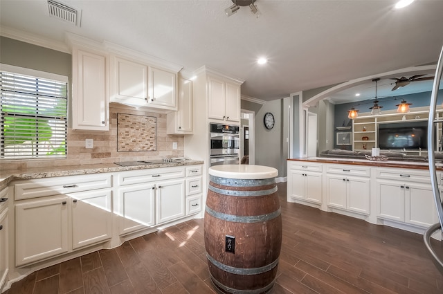 kitchen featuring white cabinets, ceiling fan, double oven, and dark hardwood / wood-style flooring