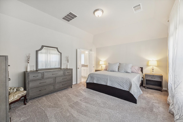 carpeted bedroom featuring connected bathroom and vaulted ceiling