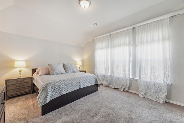 carpeted bedroom featuring lofted ceiling