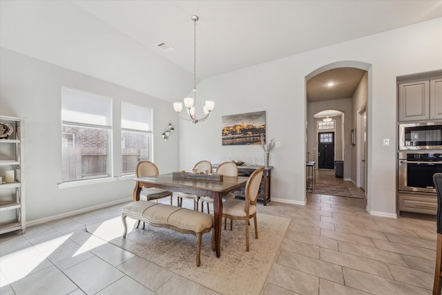 dining room featuring light tile patterned flooring and a notable chandelier