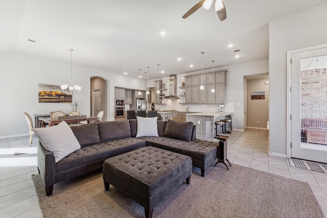 living room with ceiling fan and light tile patterned floors