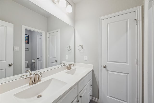 bathroom featuring vanity and toilet