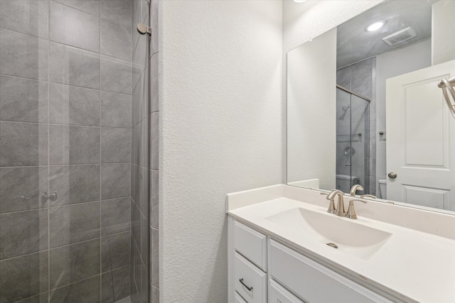 bathroom featuring vanity and walk in shower