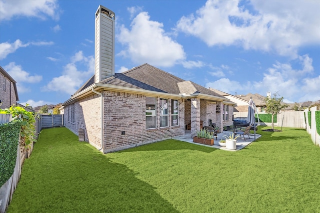 back of property with a patio and a lawn