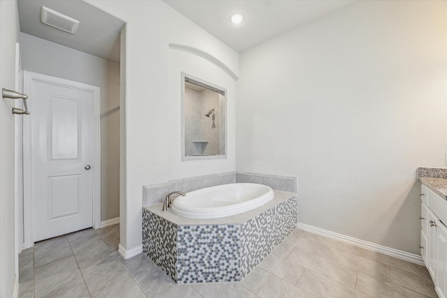 bathroom featuring vanity, plus walk in shower, and tile patterned flooring