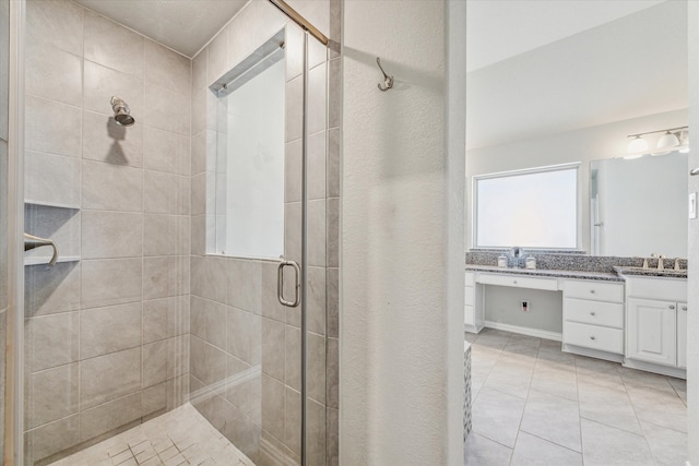 bathroom featuring vanity, tile patterned flooring, and an enclosed shower