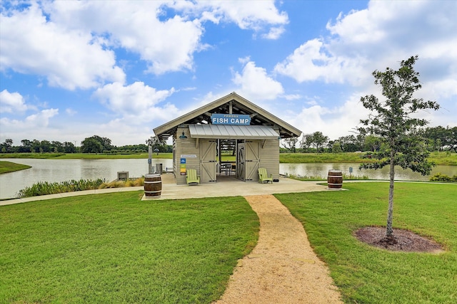 exterior space featuring a yard and a water view