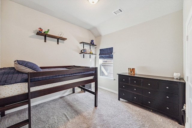 carpeted bedroom with lofted ceiling