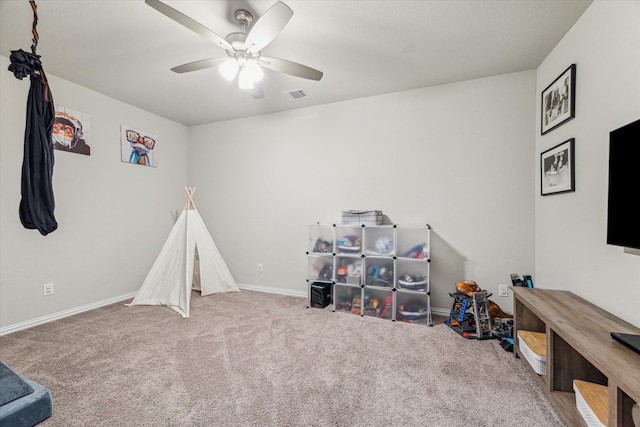 recreation room with carpet flooring and ceiling fan