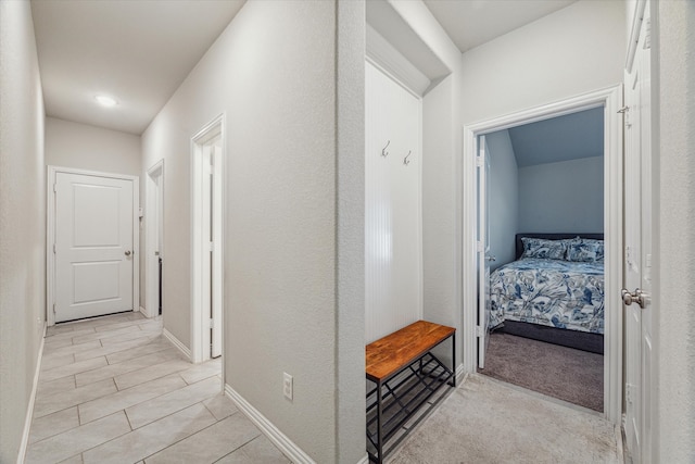 corridor with light colored carpet