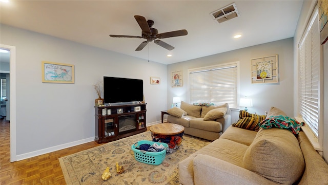 living room featuring light parquet flooring and ceiling fan