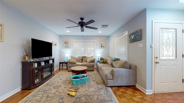 living room featuring light parquet floors, plenty of natural light, and ceiling fan