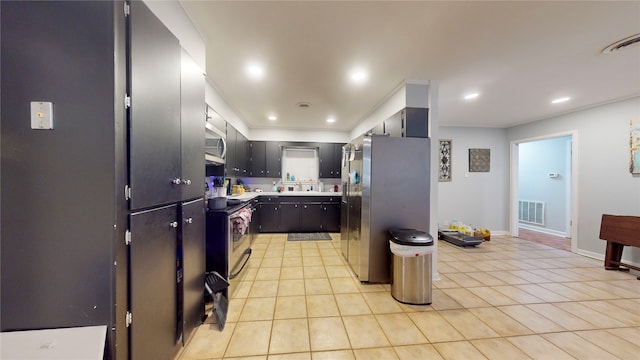 kitchen with sink, appliances with stainless steel finishes, and light tile patterned floors