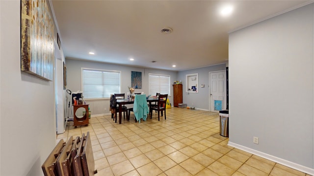 tiled dining space featuring ornamental molding