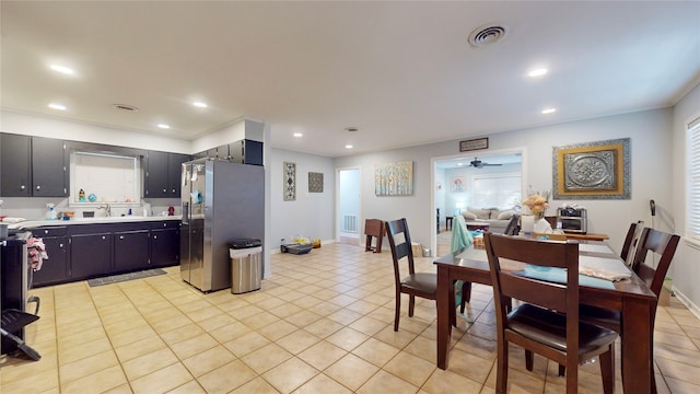 kitchen with sink, ceiling fan, light tile patterned floors, and stainless steel fridge