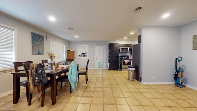 tiled dining room featuring ornamental molding