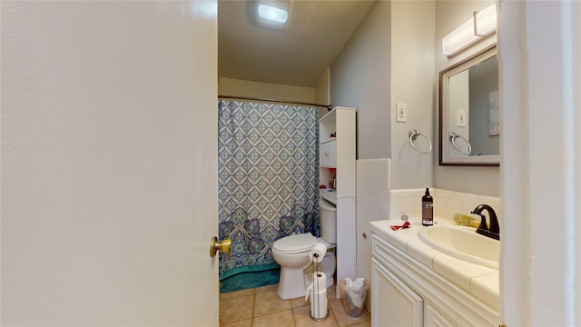 bathroom featuring vanity, curtained shower, toilet, and tile patterned floors