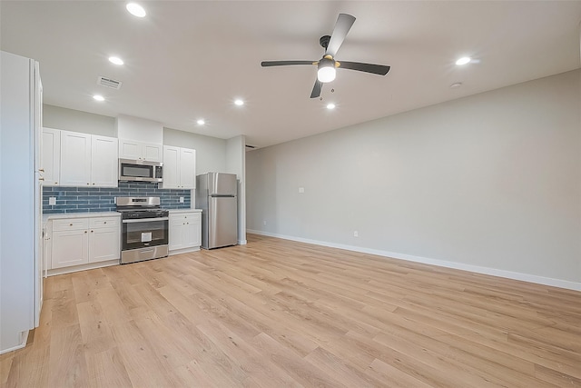 kitchen featuring appliances with stainless steel finishes, white cabinets, light wood-type flooring, and ceiling fan