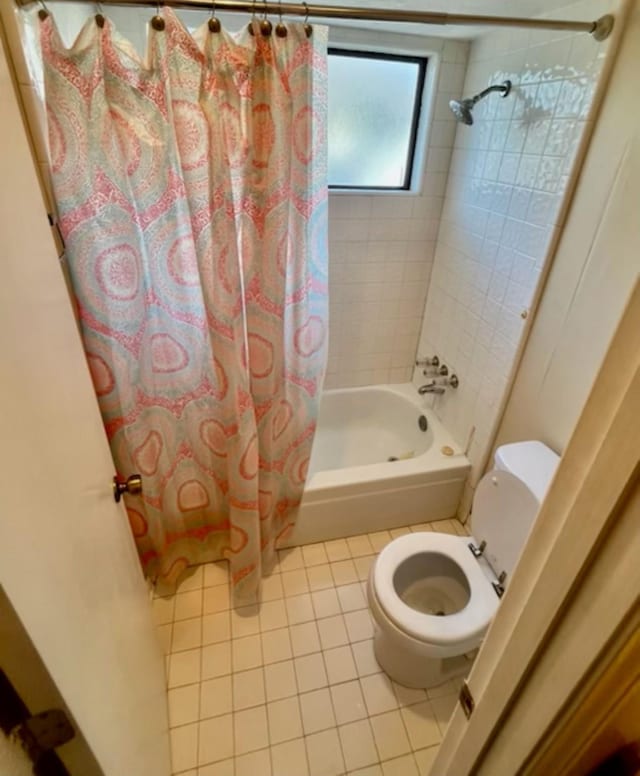 full bath featuring tile patterned floors, shower / bath combination with curtain, and toilet
