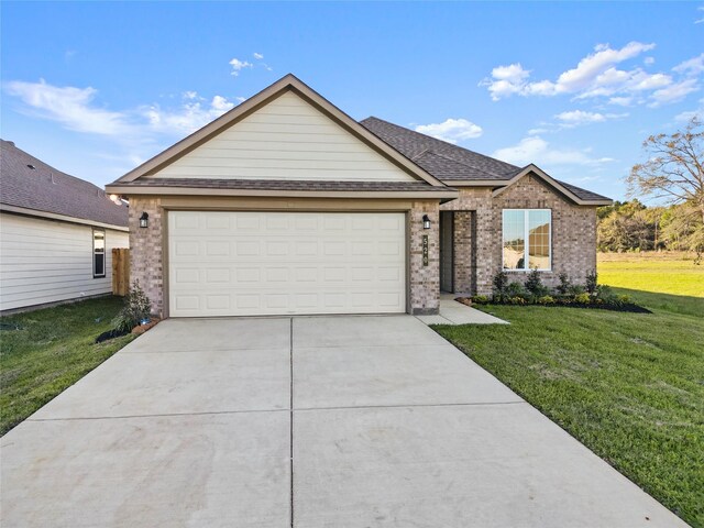 view of front of home featuring a garage and a front yard