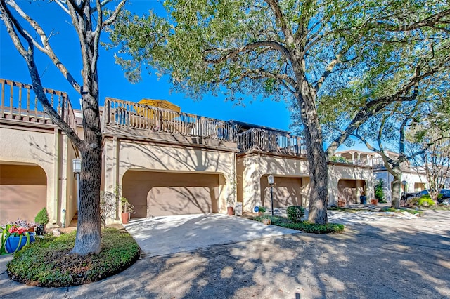 view of front of house featuring a garage and a balcony