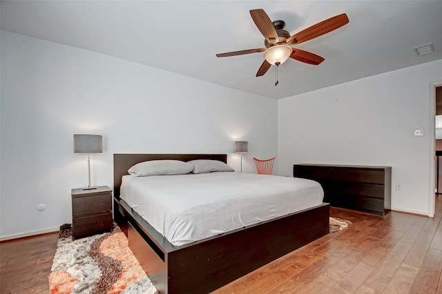 bedroom with light hardwood / wood-style floors and ceiling fan