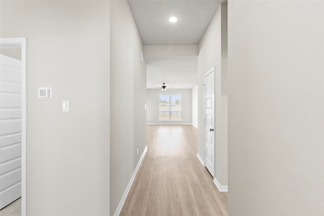 hallway with light hardwood / wood-style flooring