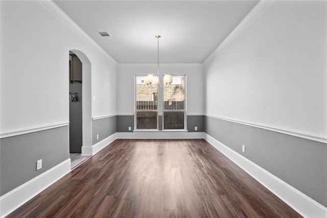 unfurnished dining area featuring ornamental molding, an inviting chandelier, and dark hardwood / wood-style floors