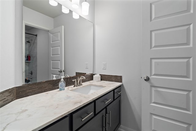 bathroom featuring vanity and a tile shower