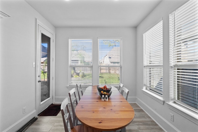 dining area featuring a wealth of natural light and hardwood / wood-style floors