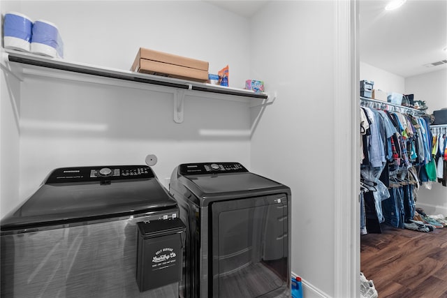 washroom with dark hardwood / wood-style flooring and separate washer and dryer