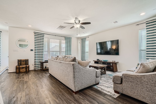 living room featuring dark hardwood / wood-style floors and ceiling fan