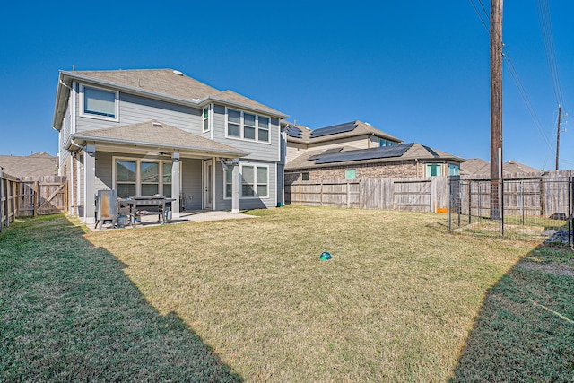 back of property featuring a patio area and a lawn