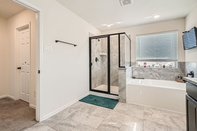 bathroom featuring vanity and independent shower and bath