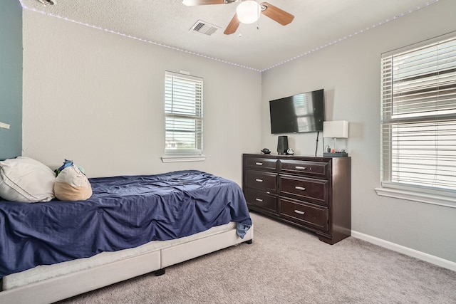 bedroom with light carpet and ceiling fan