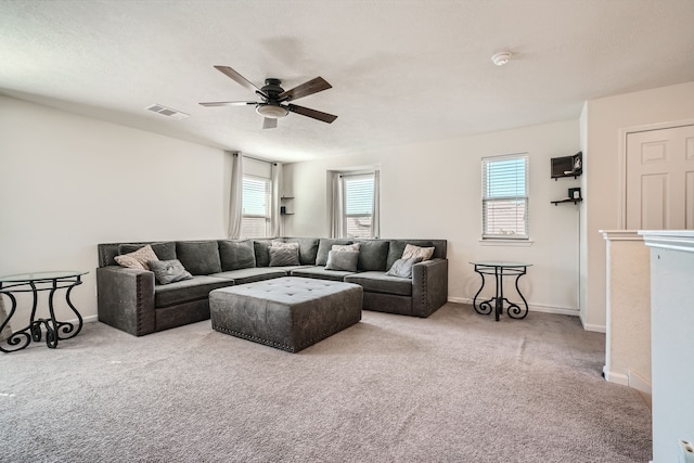 living room featuring carpet, a textured ceiling, and ceiling fan