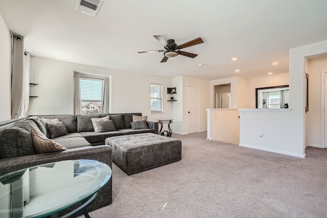 living room with light carpet and ceiling fan