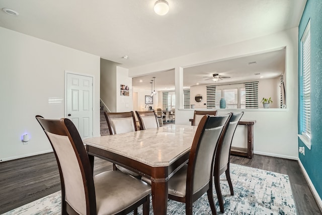 dining space featuring dark hardwood / wood-style flooring and ceiling fan