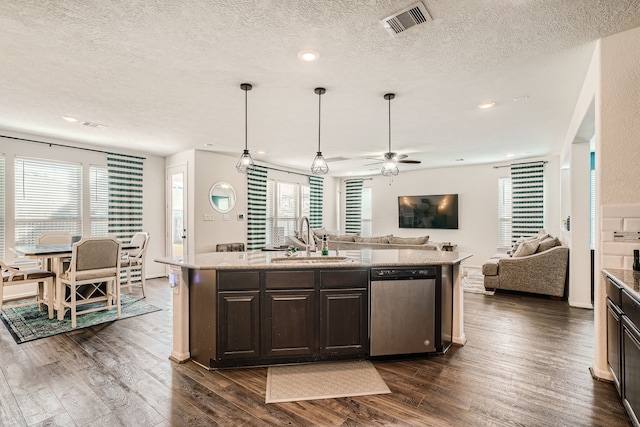 kitchen with dark hardwood / wood-style floors, dishwasher, sink, and an island with sink